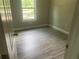 Bedroom with new gray wood-look flooring and a bright window at 841 N North Price Rd, Sugar Hill, GA 30518