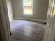 Cozy bedroom with durable wood-look flooring, a window with natural light, and neutral paint at 841 N North Price Rd, Sugar Hill, GA 30518