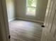 Bedroom with new gray wood-look flooring and a bright window at 841 N North Price Rd, Sugar Hill, GA 30518