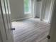 Bedroom featuring new flooring, fresh paint, and a window at 841 N North Price Rd, Sugar Hill, GA 30518