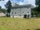 Spacious backyard featuring gray siding and a rear stairway at 841 N North Price Rd, Sugar Hill, GA 30518