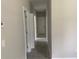 Hallway featuring neutral paint, tile flooring, and white doors at 841 N North Price Rd, Sugar Hill, GA 30518
