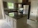 Well-lit kitchen features an island with granite countertops, stainless steel appliances, and ample storage at 841 N North Price Rd, Sugar Hill, GA 30518