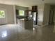 Open kitchen features an island, tile floor, and modern appliances at 841 N North Price Rd, Sugar Hill, GA 30518