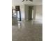 Open concept living space with tile floors, stainless steel refrigerator, and view to the kitchen at 841 N North Price Rd, Sugar Hill, GA 30518