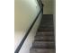 Stairway featuring wood-look steps and a modern black metal railing at 841 N North Price Rd, Sugar Hill, GA 30518