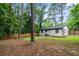 Spacious backyard with mature trees, privacy fence, wooden deck, and well-maintained lawn at 1719 San Gabriel Ave, Decatur, GA 30032