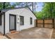 Backyard exterior showcases a white painted brick home with modern, black trim at 1719 San Gabriel Ave, Decatur, GA 30032