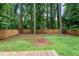 Wide backyard with wooden fence, mature trees, and a lush green lawn extending from a wooden deck at 1719 San Gabriel Ave, Decatur, GA 30032