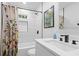 Contemporary bathroom showcasing a shower-tub combo with a floral curtain and sleek vanity at 1719 San Gabriel Ave, Decatur, GA 30032