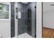 Close-up of stylish glass shower with marble tile surround and updated fixtures at 1719 San Gabriel Ave, Decatur, GA 30032