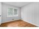 Cozy bedroom with wood-paneled walls and hardwood floors, offering a classic aesthetic at 1719 San Gabriel Ave, Decatur, GA 30032