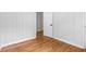 Bedroom with white wood paneled walls and hardwood floors at 1719 San Gabriel Ave, Decatur, GA 30032