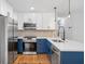 Modern kitchen boasts stainless steel appliances, blue lower cabinets, and white upper cabinets, creating a sleek design at 1719 San Gabriel Ave, Decatur, GA 30032