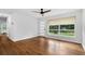 Bright and airy living room with refinished hardwood floors, a large window, and modern finishes at 1719 San Gabriel Ave, Decatur, GA 30032