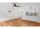 Inviting living space featuring refinished hardwood floors and an open layout to the kitchen with a ceiling fan at 1719 San Gabriel Ave, Decatur, GA 30032