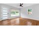 Sun-drenched living space featuring refinished hardwood floors and a modern ceiling fan at 1719 San Gabriel Ave, Decatur, GA 30032
