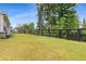 Spacious backyard enclosed by a black wooden fence offering privacy and space at 4960 Iris St, Cumming, GA 30040