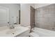 Bathroom featuring a vanity, toilet, and tiled bathtub at 4960 Iris St, Cumming, GA 30040