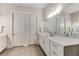 Bathroom featuring a white vanity, large mirror, and tile floor at 4960 Iris St, Cumming, GA 30040