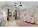 Bright Bedroom featuring floral wallpaper, modern crib, hardwood floors and a large window at 4960 Iris St, Cumming, GA 30040