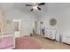 Bright Bedroom featuring hardwood floors, floral wallpaper, and modern crib at 4960 Iris St, Cumming, GA 30040