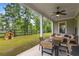 Inviting covered patio featuring comfortable seating, ceiling fan, and a view of the expansive backyard at 4960 Iris St, Cumming, GA 30040