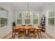 The dining room has natural light and a decorative chandelier over the wooden table at 4960 Iris St, Cumming, GA 30040