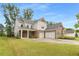 Beautiful two-story home featuring a brick and siding exterior, a three-car garage, and a well-manicured lawn at 4960 Iris St, Cumming, GA 30040