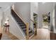 Grand foyer with hardwood floors, staircase, and an open view of the front door at 4960 Iris St, Cumming, GA 30040