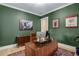 Another view of home office with green walls, hardwood floors, desk and office chair at 4960 Iris St, Cumming, GA 30040