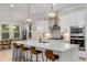 Modern kitchen boasts white cabinets, stainless steel appliances, a large island, and stylish pendant lighting at 4960 Iris St, Cumming, GA 30040