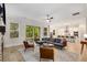 Open concept living room with hardwood floors, large couch, and seamless transition to the kitchen at 4960 Iris St, Cumming, GA 30040