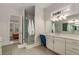 Bright bathroom featuring a glass-enclosed shower, dual sinks, and a makeup vanity at 4960 Iris St, Cumming, GA 30040