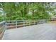 Wooden back deck with natural view surrounded by mature green trees at 4981 Crowe Se Dr, Smyrna, GA 30082