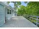 Wide back deck on home exterior with natural view surrounded by mature green trees at 4981 Crowe Se Dr, Smyrna, GA 30082
