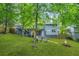 Large backyard with lush green grass, patio, and fire pit at 4981 Crowe Se Dr, Smyrna, GA 30082