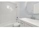 Well lit bathroom featuring a shower over the bath, white subway tiles and a modern white vanity at 4981 Crowe Se Dr, Smyrna, GA 30082