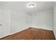 Bedroom with hardwood floors, neutral walls, ceiling light and two closet doors at 4981 Crowe Se Dr, Smyrna, GA 30082