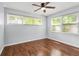 Bedroom with hardwood floors, neutral walls, ceiling fan, and natural light from the double windows at 4981 Crowe Se Dr, Smyrna, GA 30082