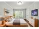 Cozy bedroom featuring a wooden bed frame, stylish art, and a window for natural light at 4981 Crowe Se Dr, Smyrna, GA 30082