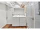 Basement laundry area with white washer and dryer and access door at 4981 Crowe Se Dr, Smyrna, GA 30082