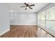 Bright living room with hardwood floors, ceiling fan, and large windows at 4981 Crowe Se Dr, Smyrna, GA 30082