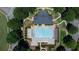 Aerial view of a community pool with lounge chairs, umbrellas, and landscaping at 6765 Creek View Ln, Cumming, GA 30041