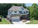 Charming two-story home featuring a well-maintained lawn and a large attached two car garage at 6765 Creek View Ln, Cumming, GA 30041
