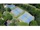 Aerial view of multiple well-maintained tennis courts surrounded by lush greenery at 6765 Creek View Ln, Cumming, GA 30041