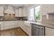 Well-lit kitchen showcasing modern appliances, a farmhouse sink, and beautiful countertops at 830 Stone Ridge Ln, Atlanta, GA 30324