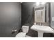Elegant powder room with modern fixtures, textured wallpaper, and decorative mirror at 830 Stone Ridge Ln, Atlanta, GA 30324