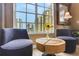Cozy seating area with chairs, hardwood floors, and bright window overlooking city buildings at 1101 Juniper Ne St # 922, Atlanta, GA 30309