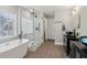 Bright bathroom featuring a standalone tub, seamless glass shower, and double sink vanity at 112 Rotherhithe Nw Ln, Marietta, GA 30066